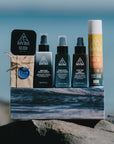 Ninth Wave Complete Sun Recovery System arranged on a rock at the beach to highlight its surf and sun recovery roots