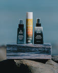 Ninth Wave Morning Routine products placed at the beach.