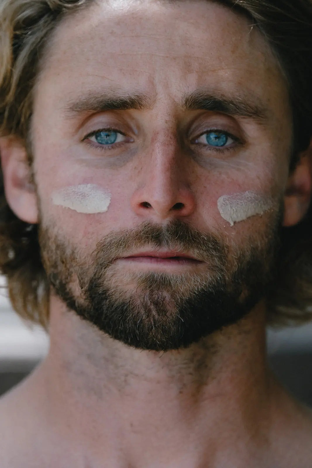 Close-up of man with visible zinc stripe on his nose for sun protection