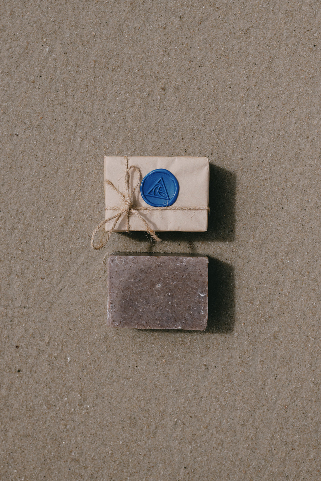 Ninth Wave Recovery Bar Magnesium Sea Salt Soap resting on the sand at the beach to reflect ocean-inspired body care