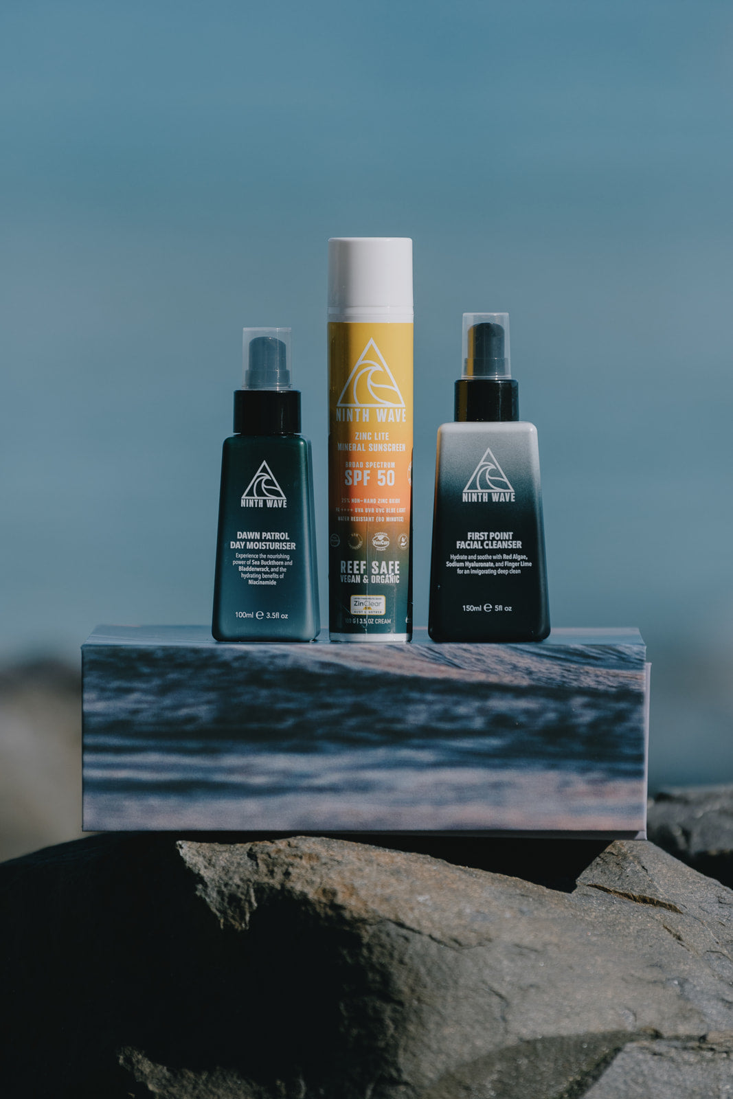 Ninth Wave Morning Routine products placed at the beach.